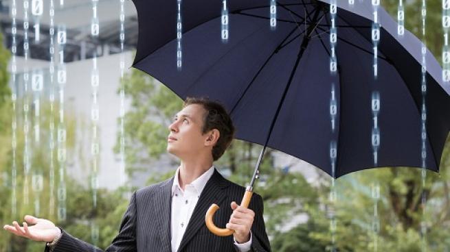 a person that is standing in the rain holding an umbrella